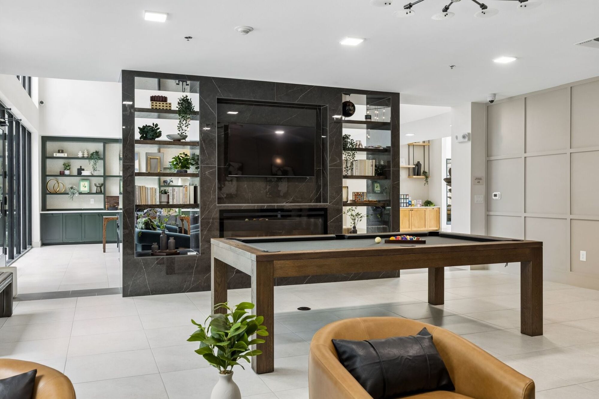 Modern clubroom at The Elara in Farmers Branch, TX featuring a pool table and upscale resident lounge space near Dallas, TX