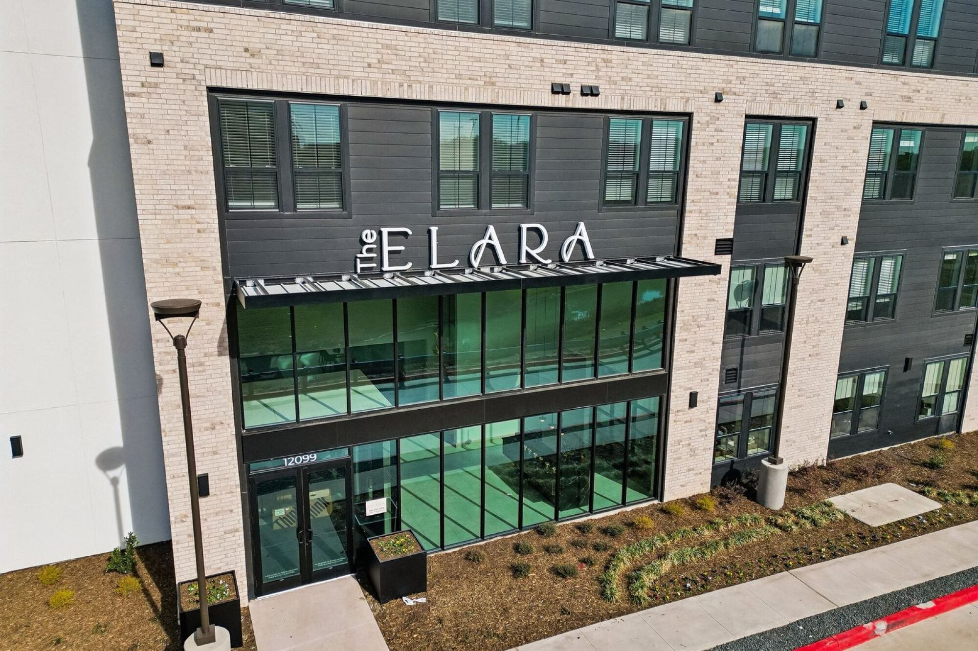 Exterior view of The Elara Apartments in Farmers Branch, TX near Dallas