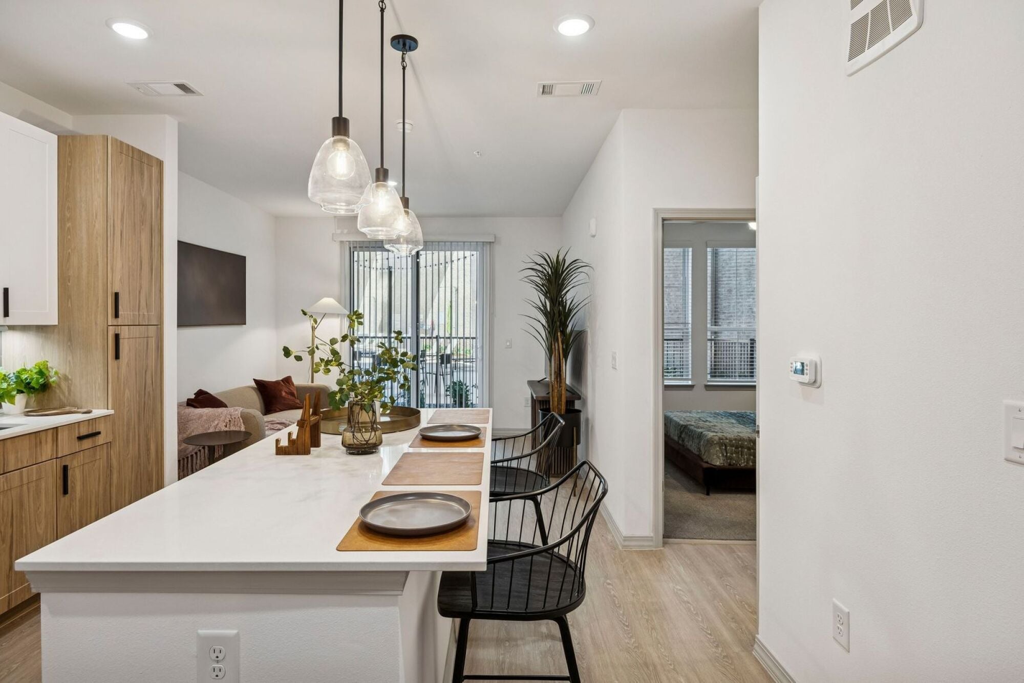 Modern kitchen with stainless steel appliances and tile backsplash at The Elara Apartments