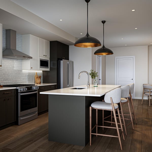 Modern kitchen with a large island, three chairs, pendant lights, and stainless steel appliances.