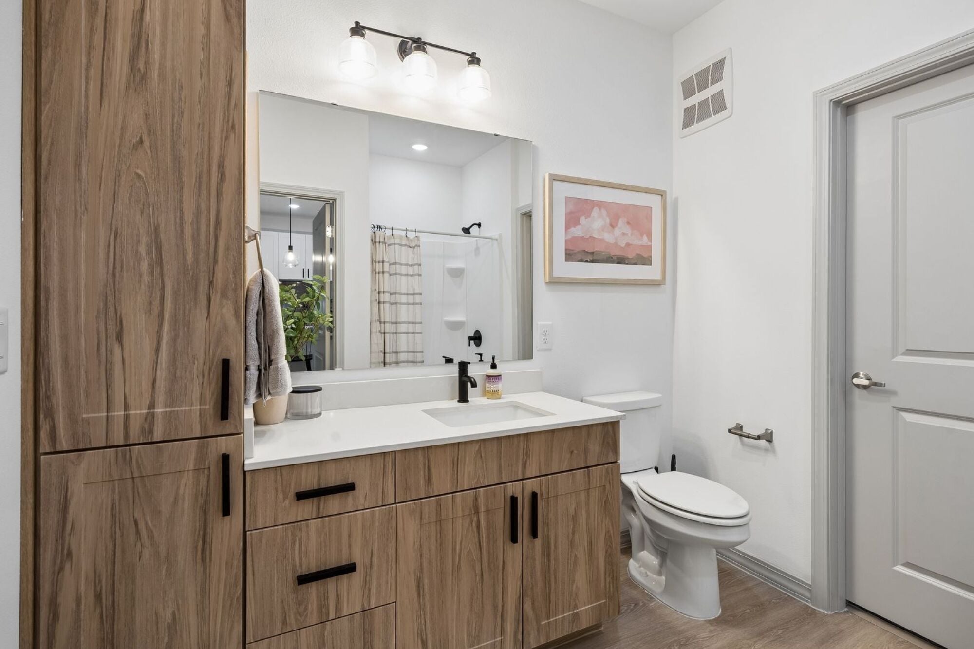Modern bathroom at The Elara in Farmers Branch, TX featuring contemporary fixtures and sleek finishes near Dallas, TX