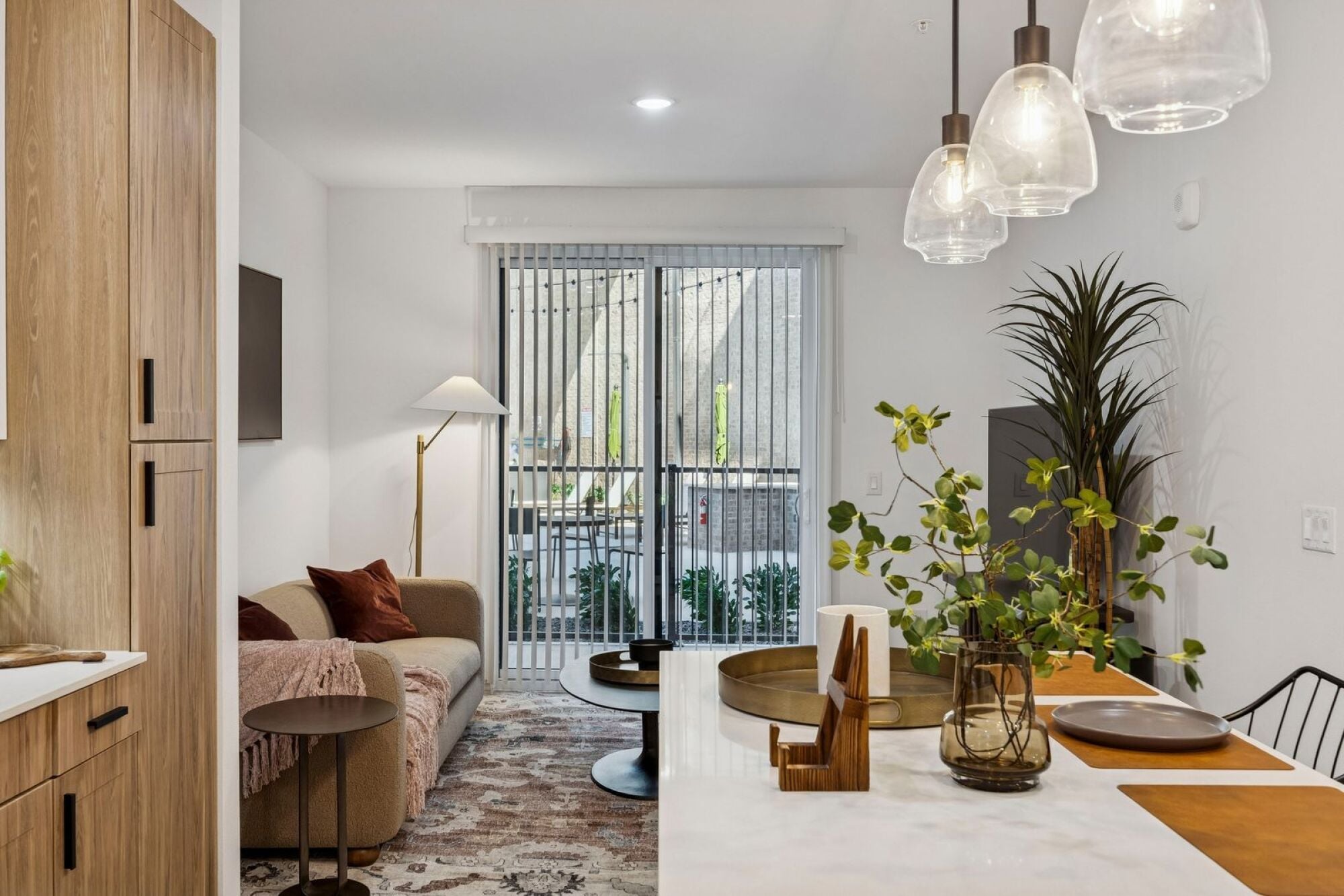 Open-concept kitchen and living room at The Elara Apartments in Farmers Branch, TX
