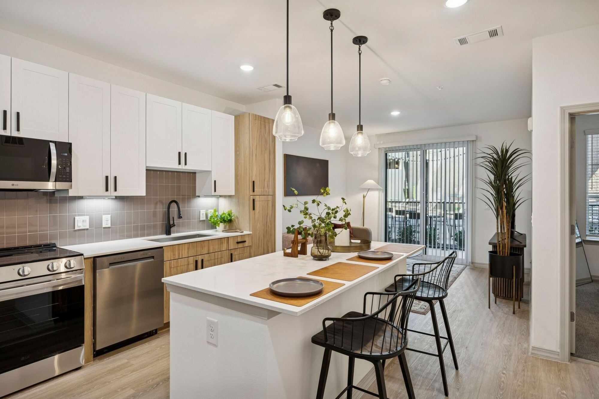 Bright kitchen with stainless steel appliances at The Elara in Farmers Branch, TX