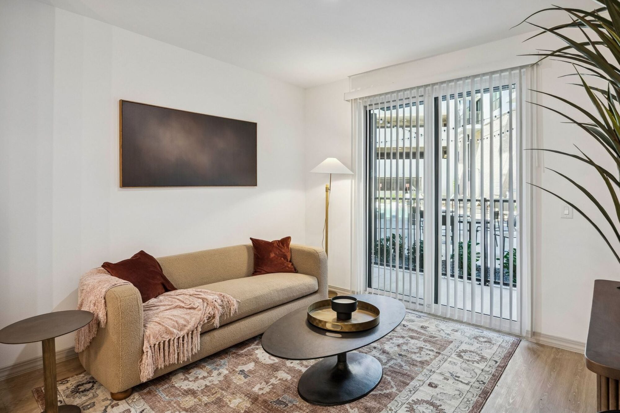 A living room with a balcony at The Elara in Farmers Branch, Texas.