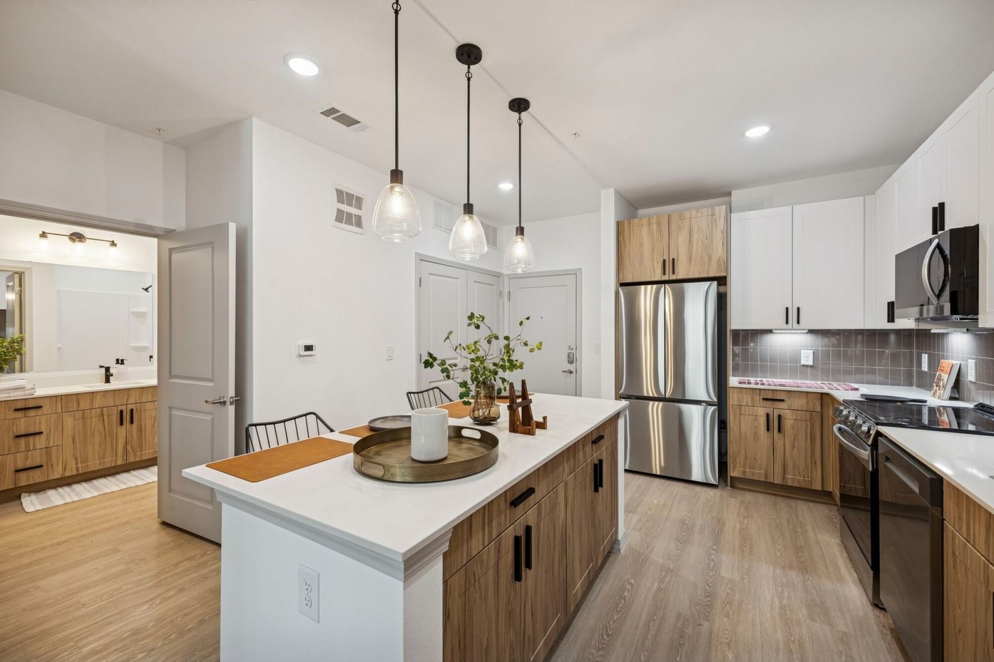 A large kitchen with stainless steel appliances at The Elara in Farmers Branch, Texas.
