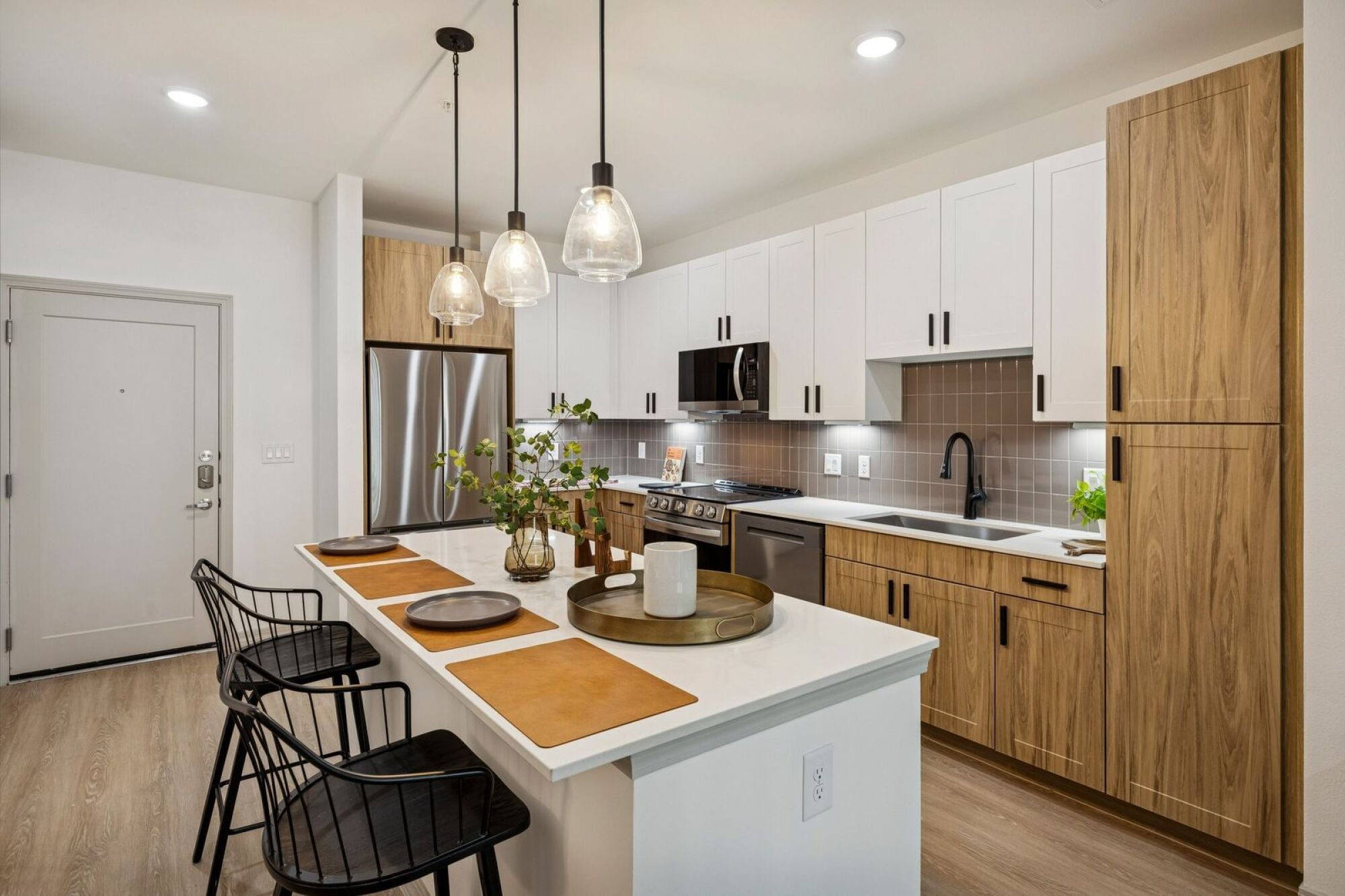 A kitchen with a large center island at The Elara in Farmers Branch, Texas.