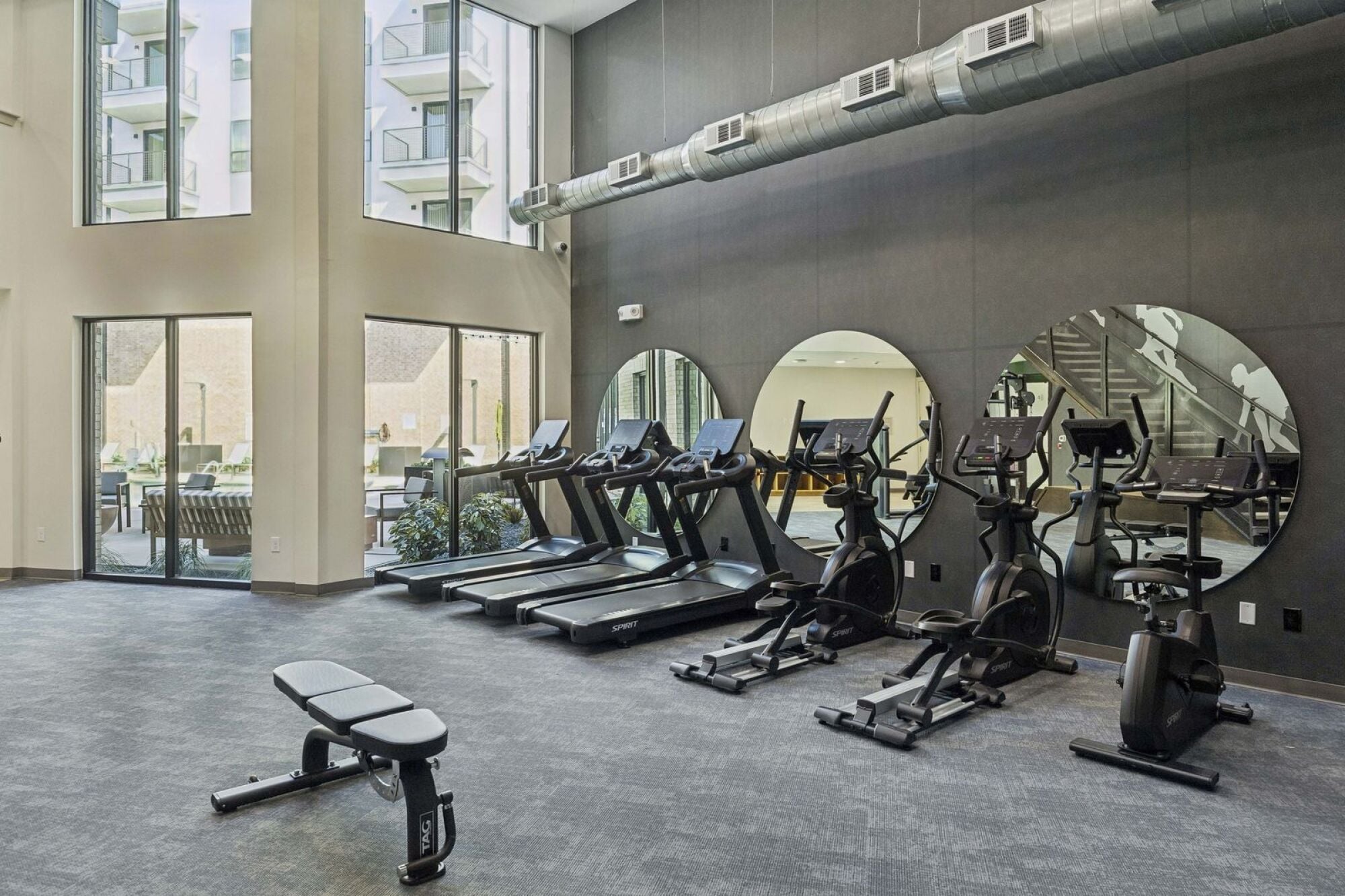 Two-level gym and fitness center at The Elara in Farmers Branch, TX with dedicated training spaces and fitness equipment near Dallas, TX
