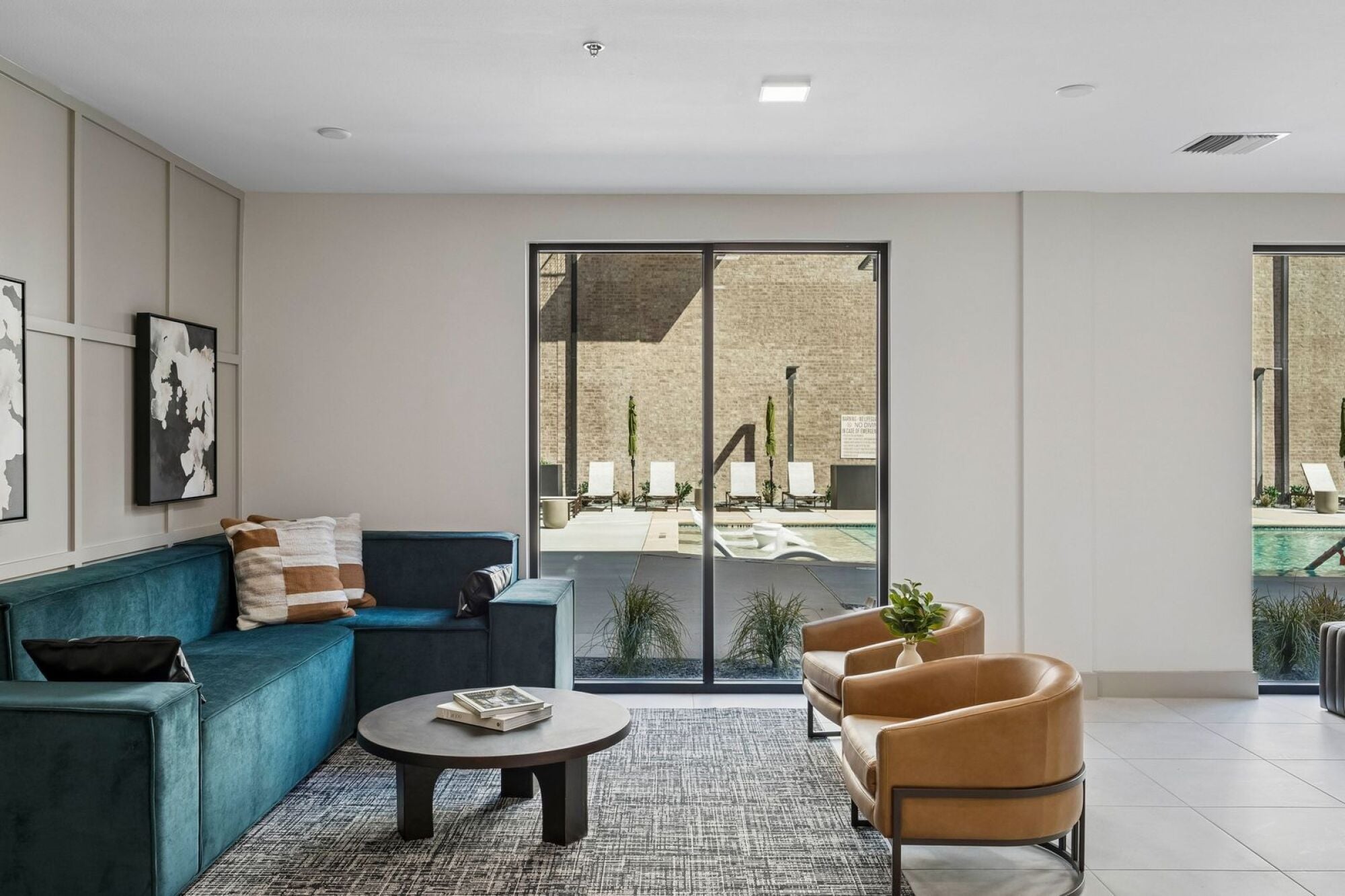 Modern lobby at The Elara Apartments in Farmers Branch, TX featuring upscale finishes, comfortable seating, and welcoming resident entry near Dallas, TX
