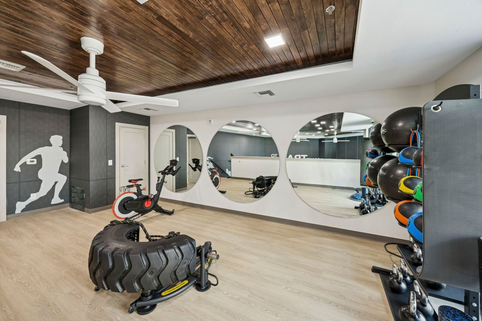 Two-level fitness center at The Elara Apartments in Farmers Branch, TX featuring modern cardio and strength training equipment near Dallas, TX