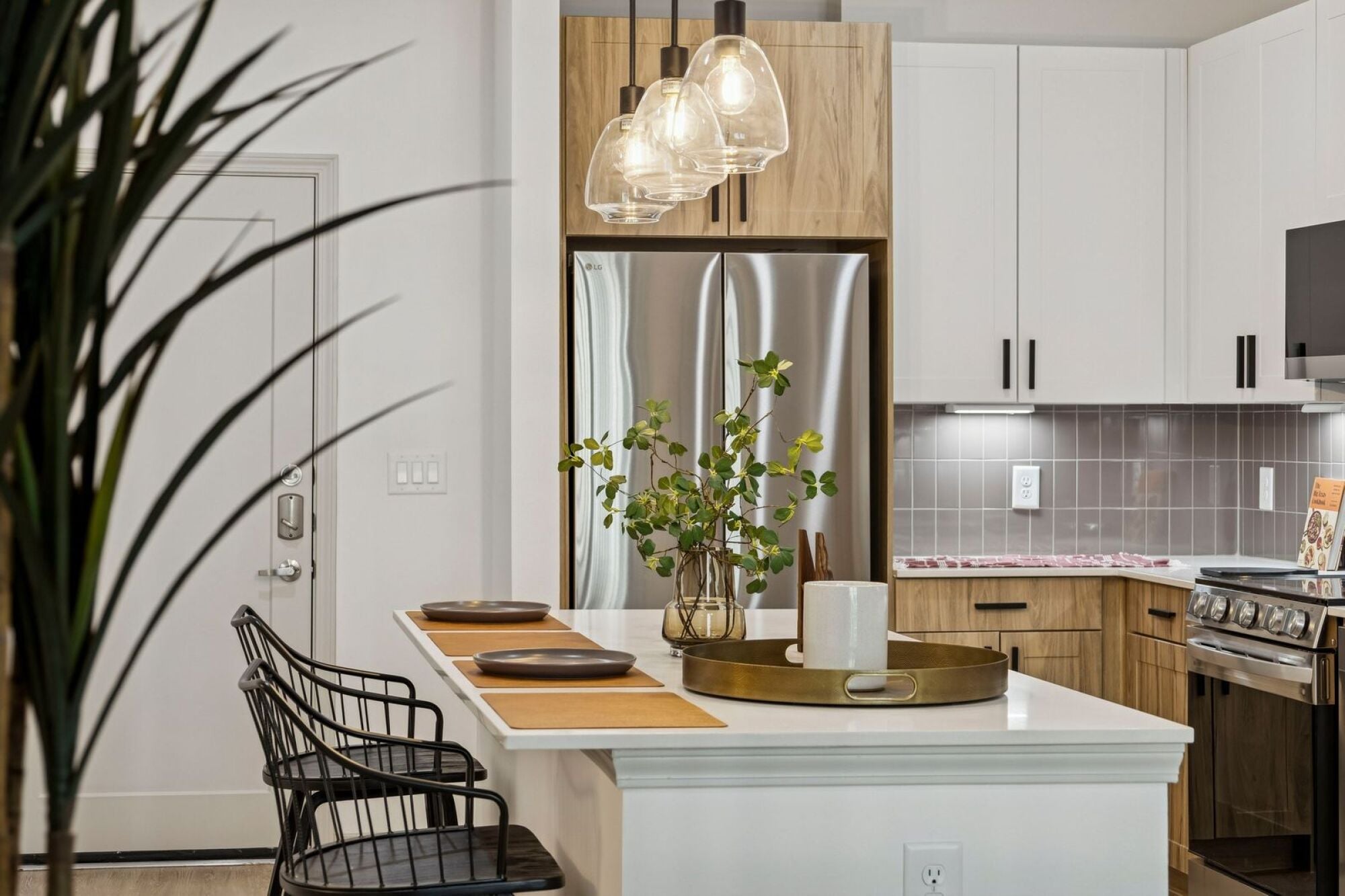 Spacious apartment kitchen at The Elara in Farmers Branch, TX with modern cabinetry and updated appliances near Dallas