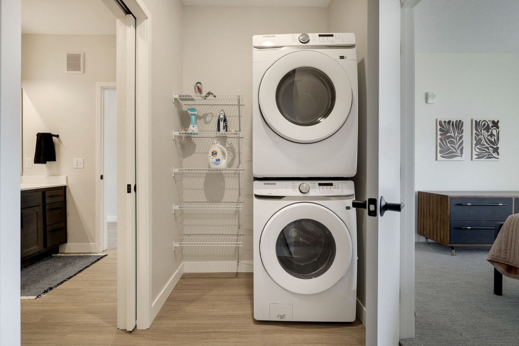A white washing machine and dryer in a laundry room at The Blakeley in Shakopee, MN.