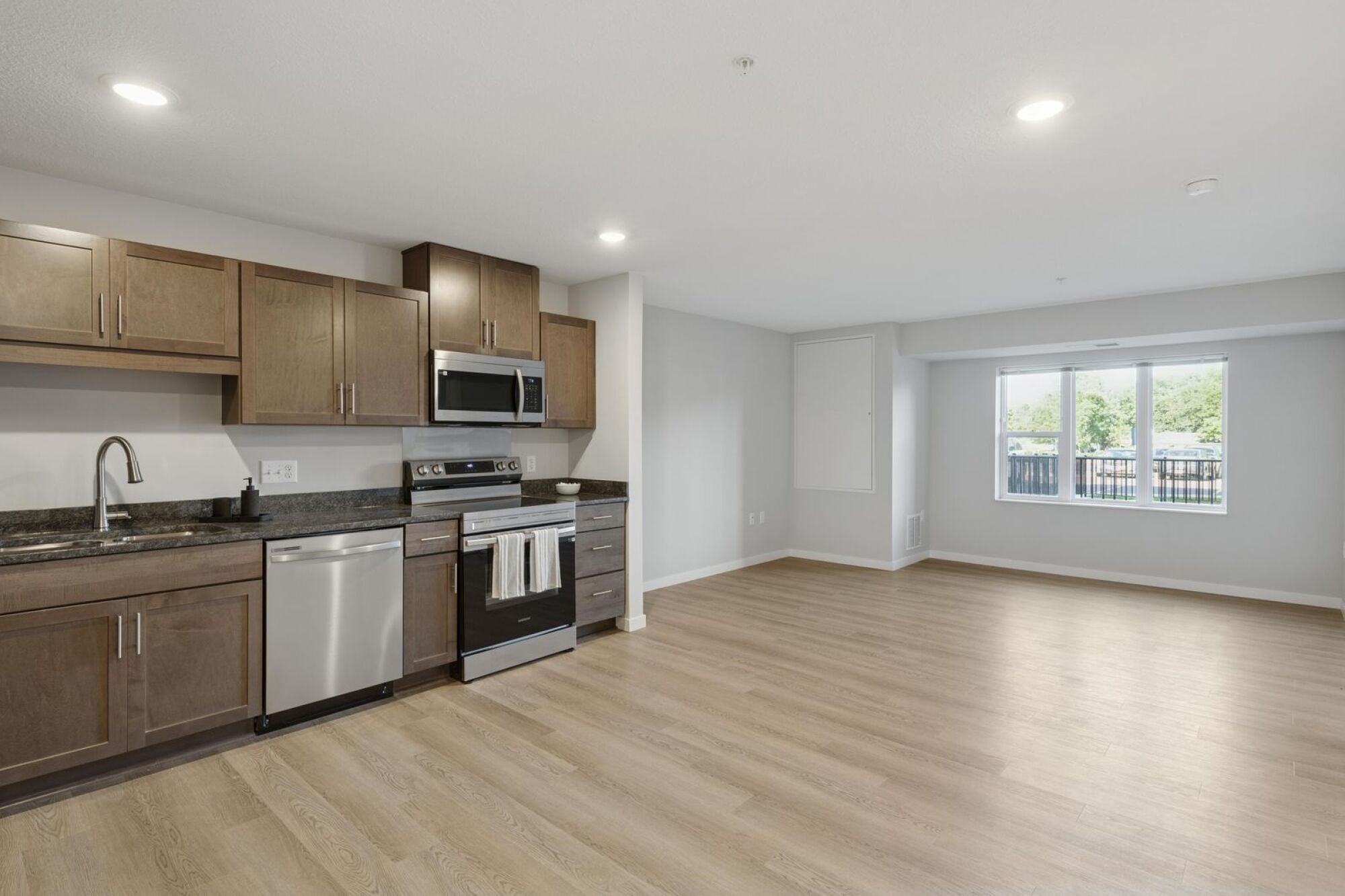 A kitchen and living room at Callisto Commons in Fridley, MN.