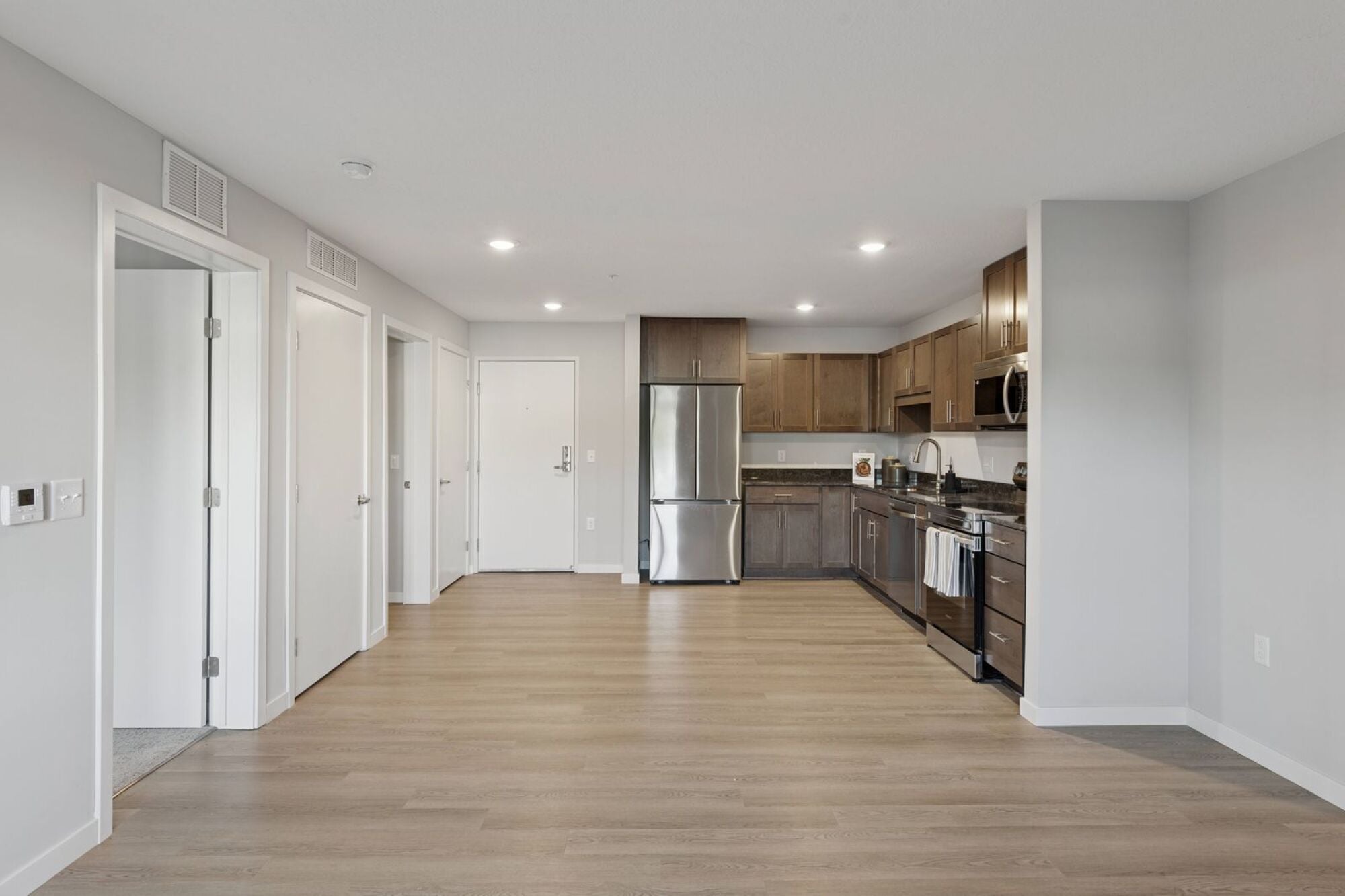 A kitchen and living room at Callisto Commons in Fridley, MN.
