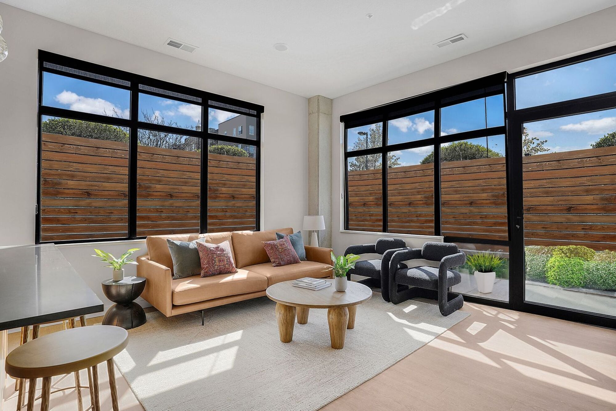 A modern living room with a sofa, chairs, and a coffee table at The Whitney in Salt Lake City, Utah.