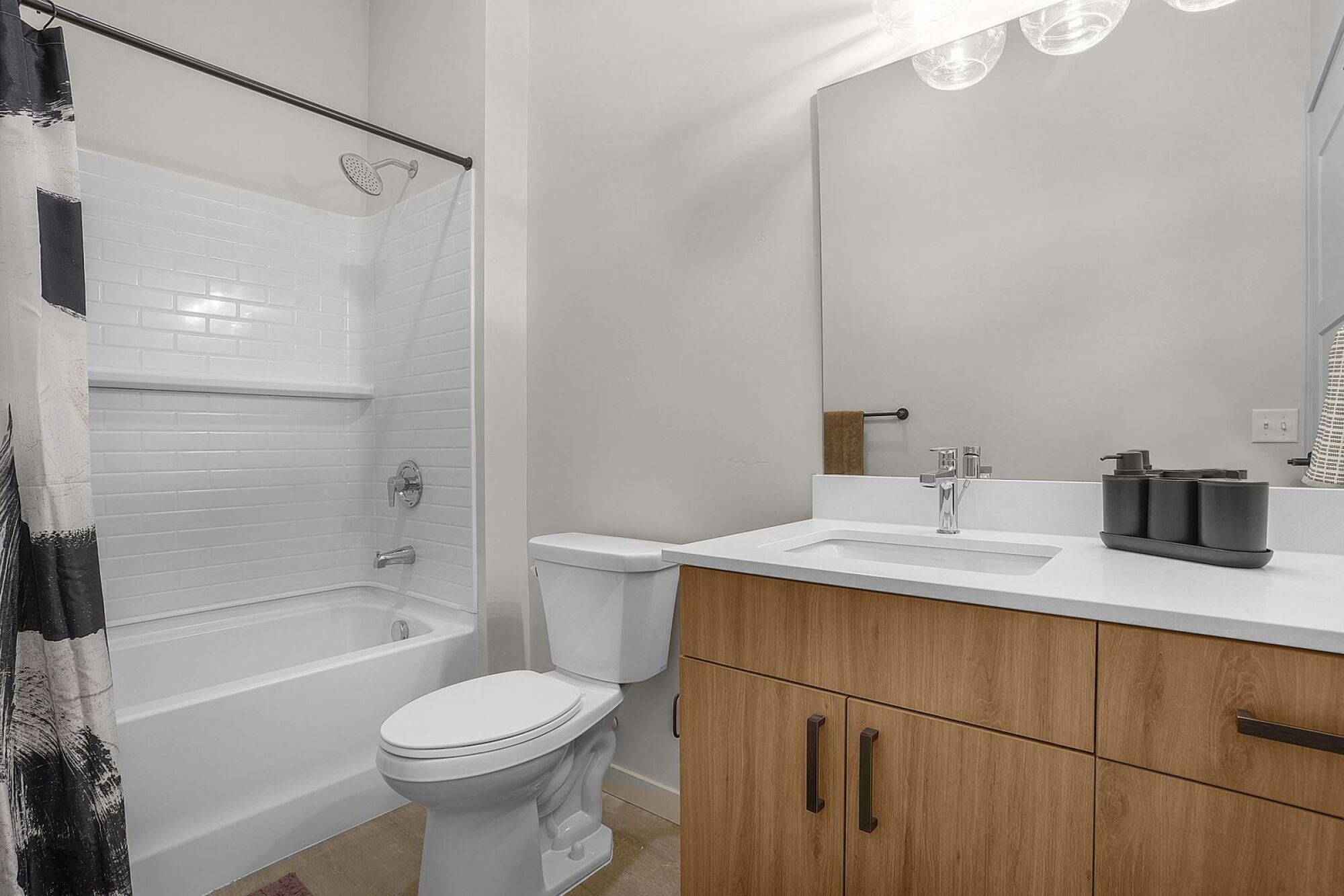 A white toilet sits next to a white sink in a bathroom at The Whitney in Salt Lake City, Utah.