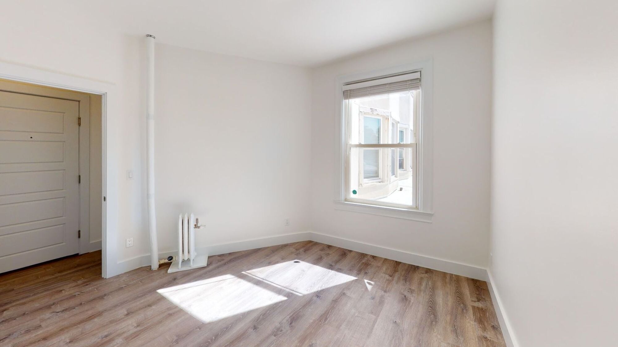 A room with a window and a door.