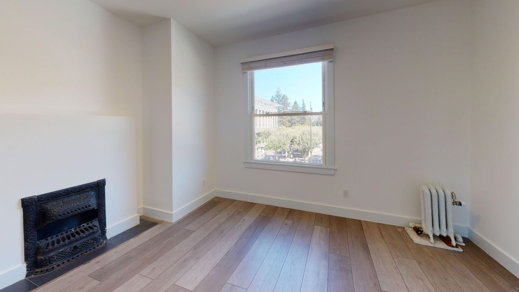 A room with a fireplace and a window.