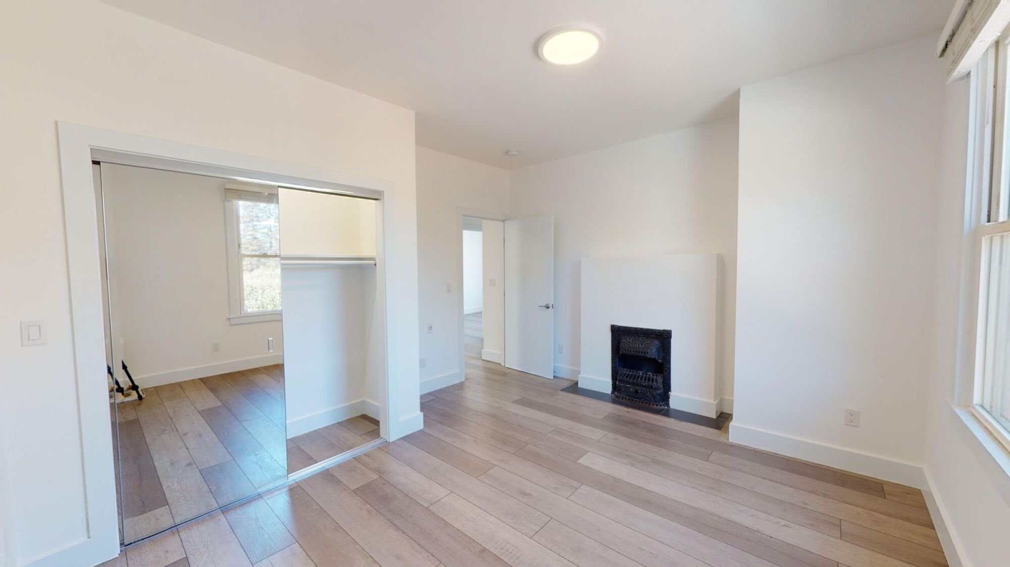 A room with a fireplace and a sliding door.