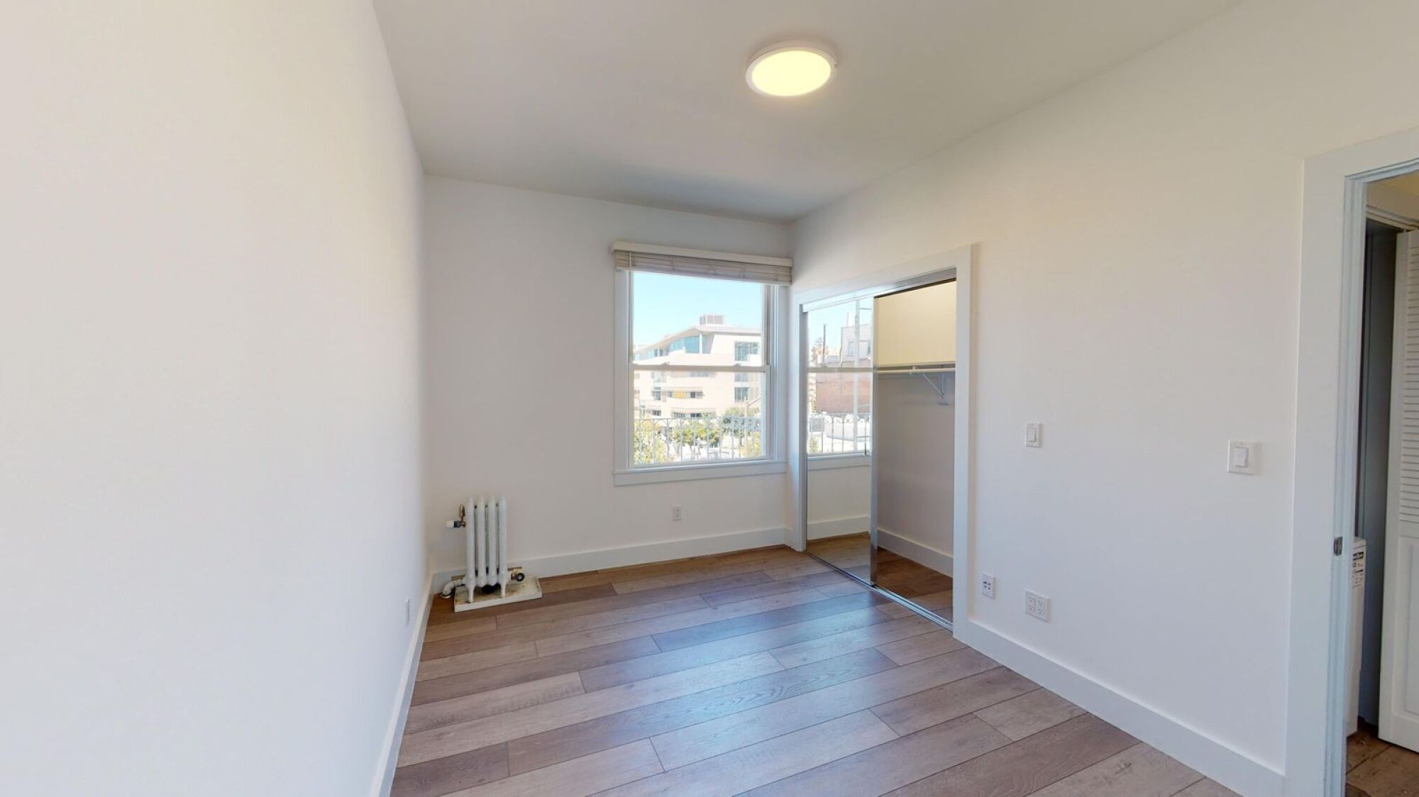 A room with a window and a sliding door.