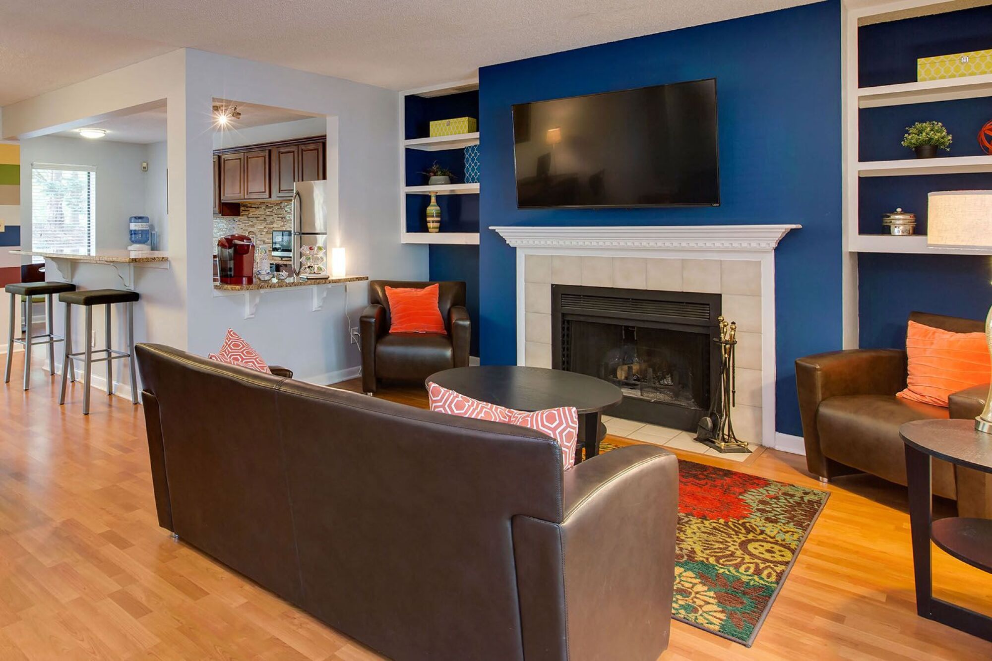 Resident lounge with fireplace, seating and kitchen with coffee station at Laurel Oaks, Raleigh, NC, 27613