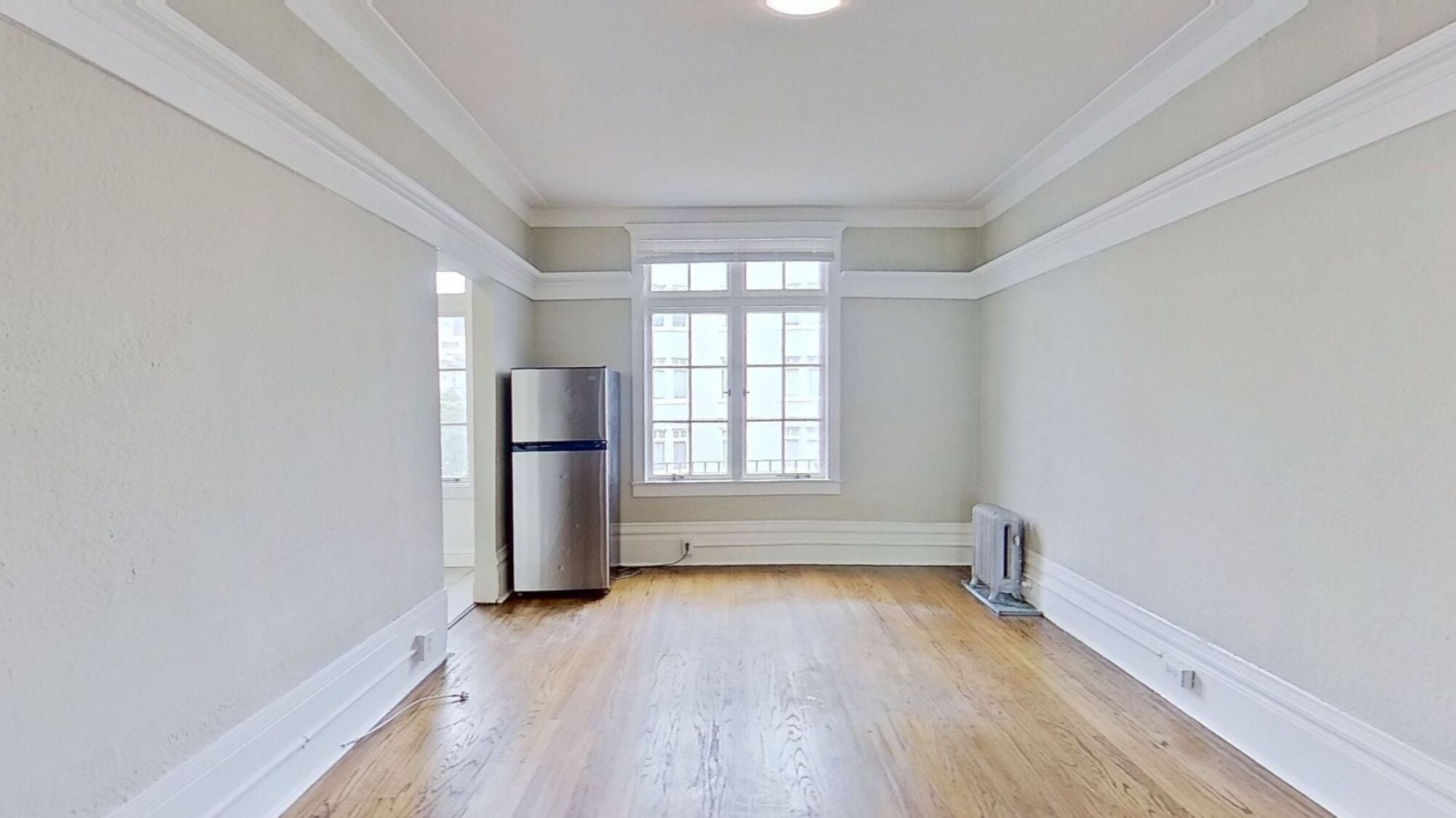 A room with a wooden floor and a window.