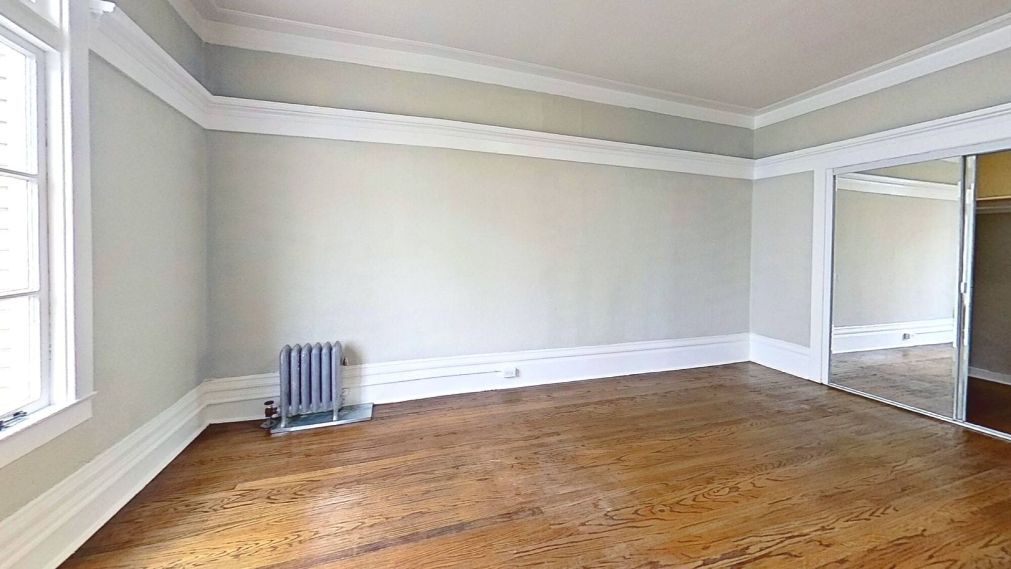 A room with wooden floors and a window.