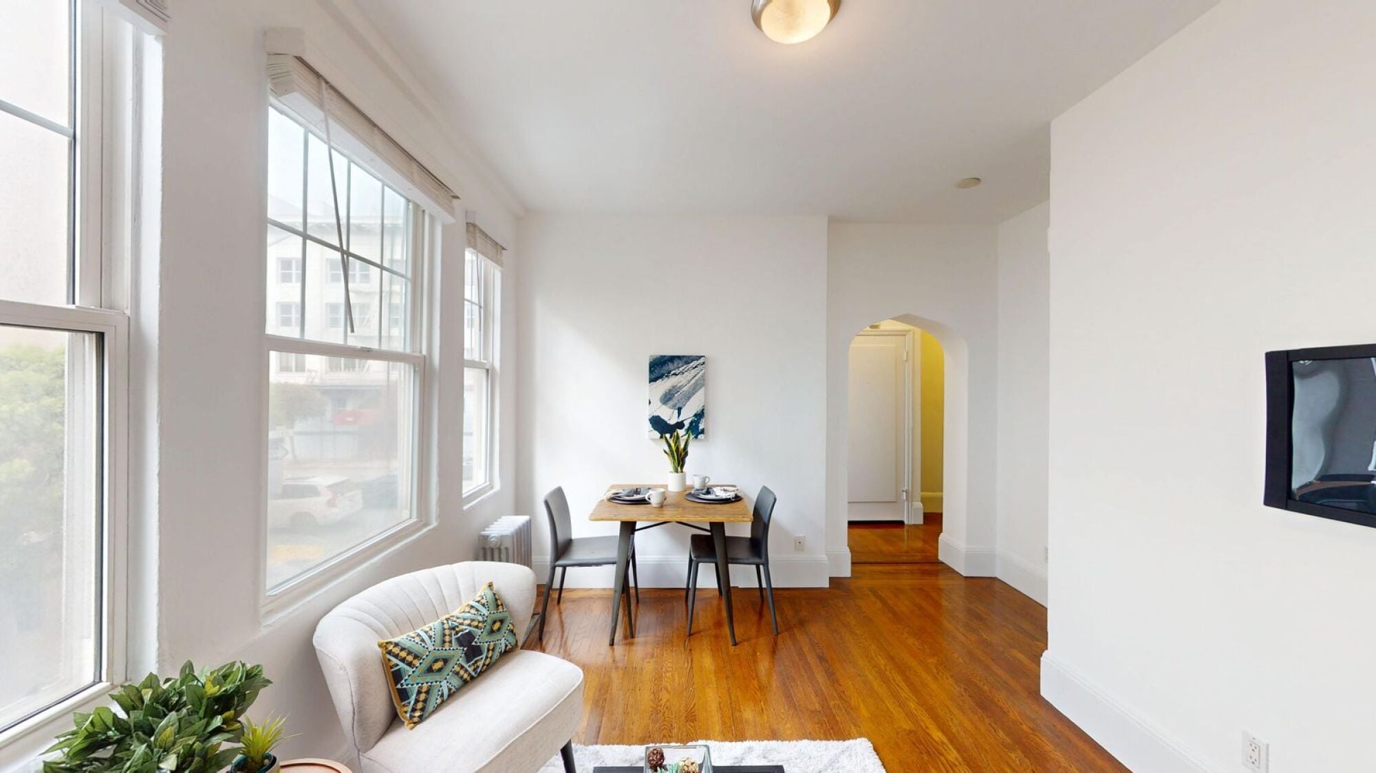 A living room with a white couch and a coffee table.