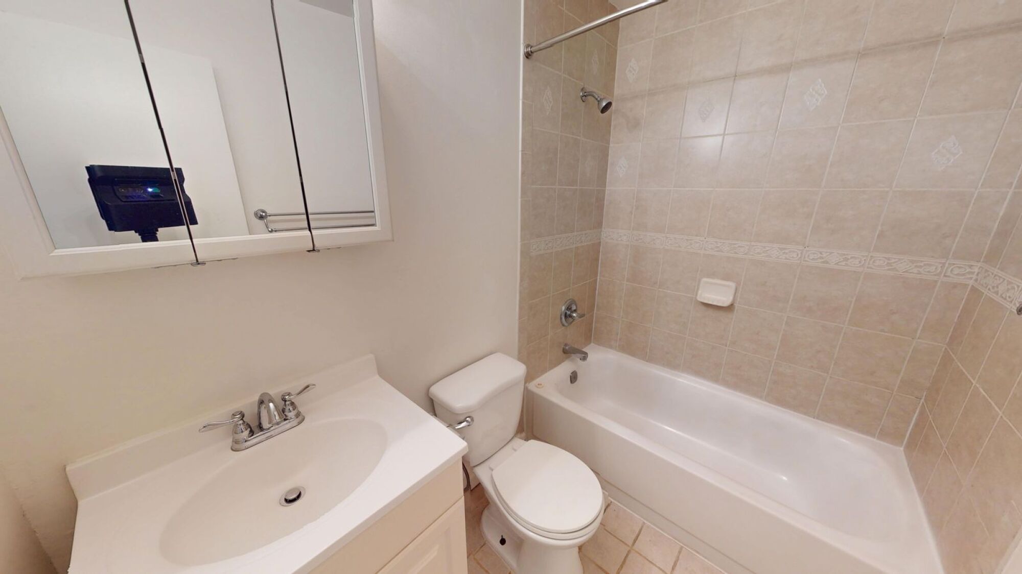 A white bathroom with a sink, toilet, and bathtub.