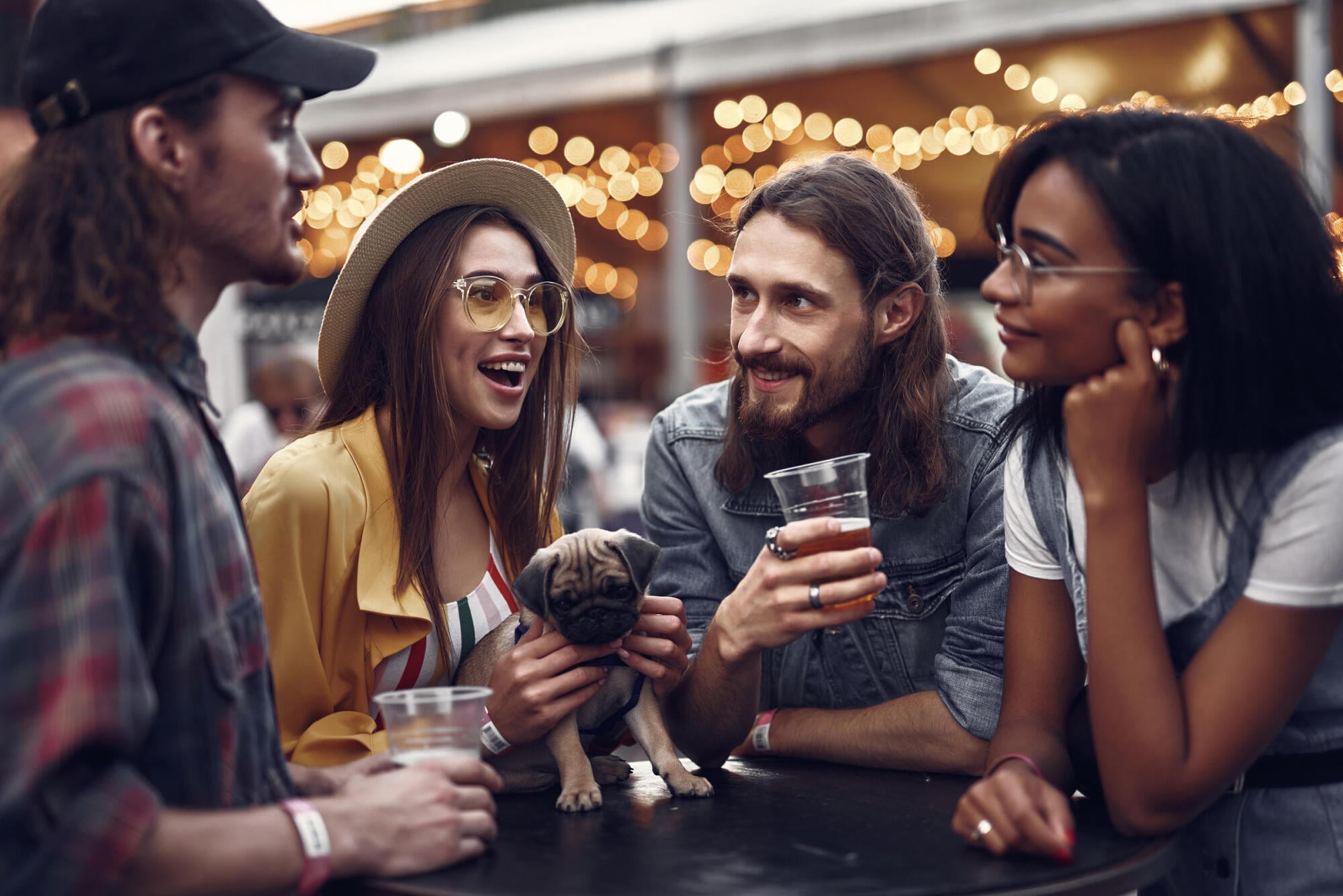 Friends and a playful pug enjoying a community festival near The Sterling at Center Point in Wilmington, NC.