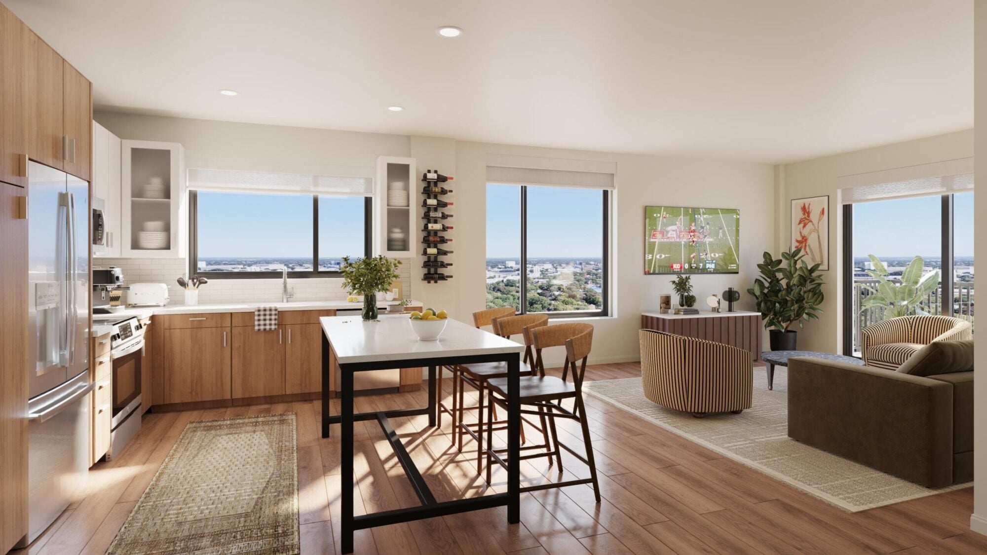 Bright, modern kitchen and dining area with large windows, wood floors, and contemporary furniture.