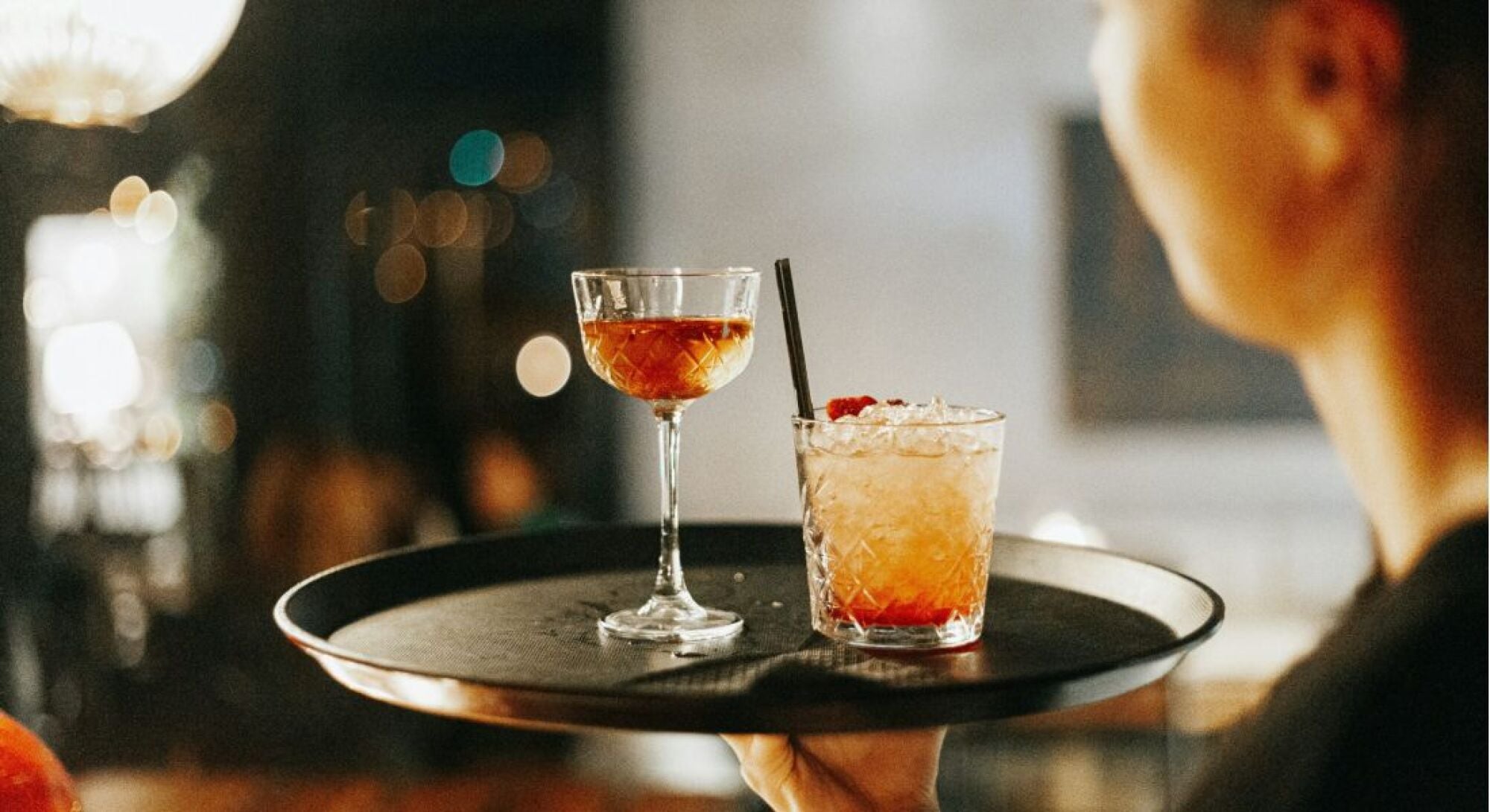 Bartender at local bar pouring a cocktail