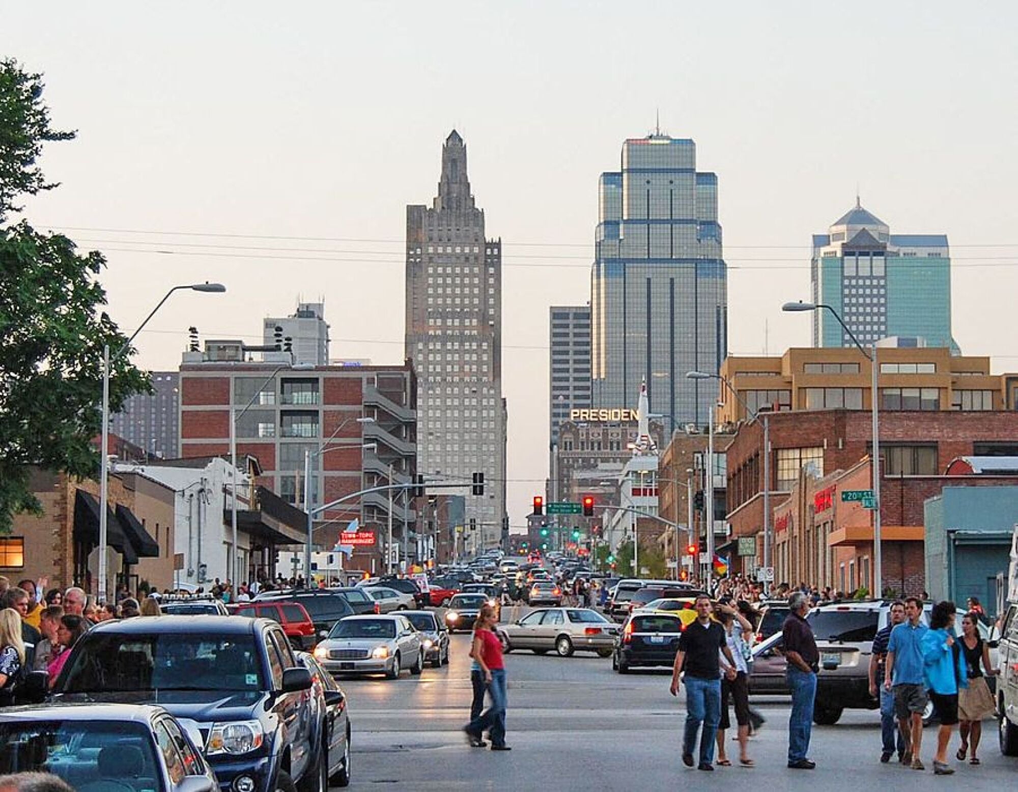 The Wade A bustling city street filled with pedestrians and vehicles, showcasing the vibrant energy of urban life.