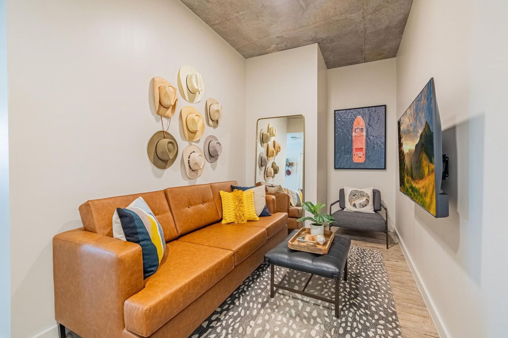 Designer living room with 55-inch smart TV at Rev student apartments in College Station, TX.