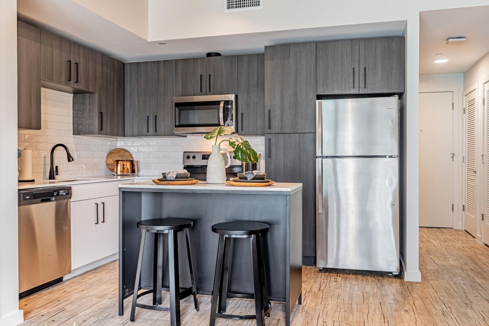 Chef-inspired kitchen with quartz countertops and stainless steel appliances at Rev in College Station, TX.
