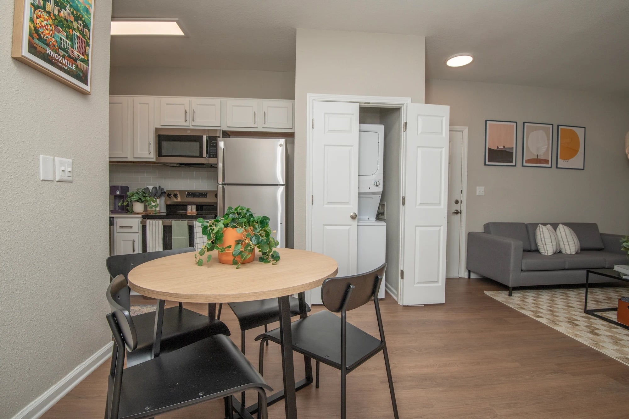 Open kitchen and dining area at The Heights with stainless steel appliances and in-home laundry.
