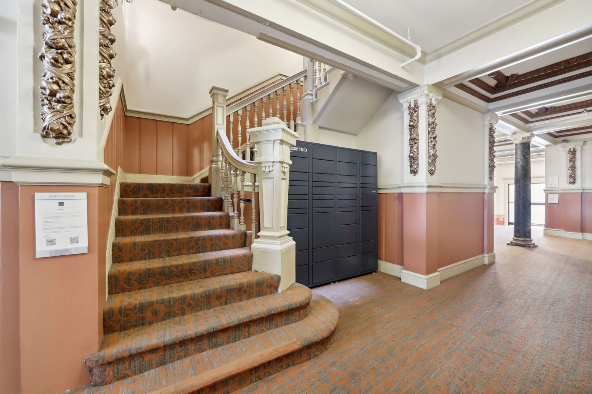 A staircase with a white railing and a sign on the wall.