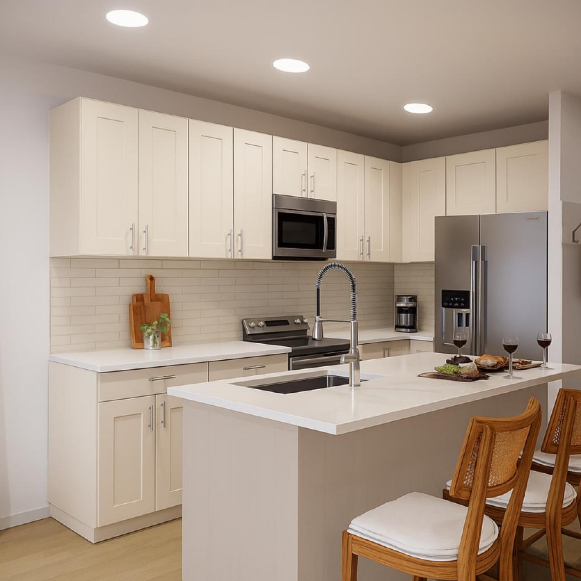 Apartment kitchen at The Sterling at Center Point in Wilmington, NC, with quartz countertops, stainless steel appliances, and custom cabinetry.