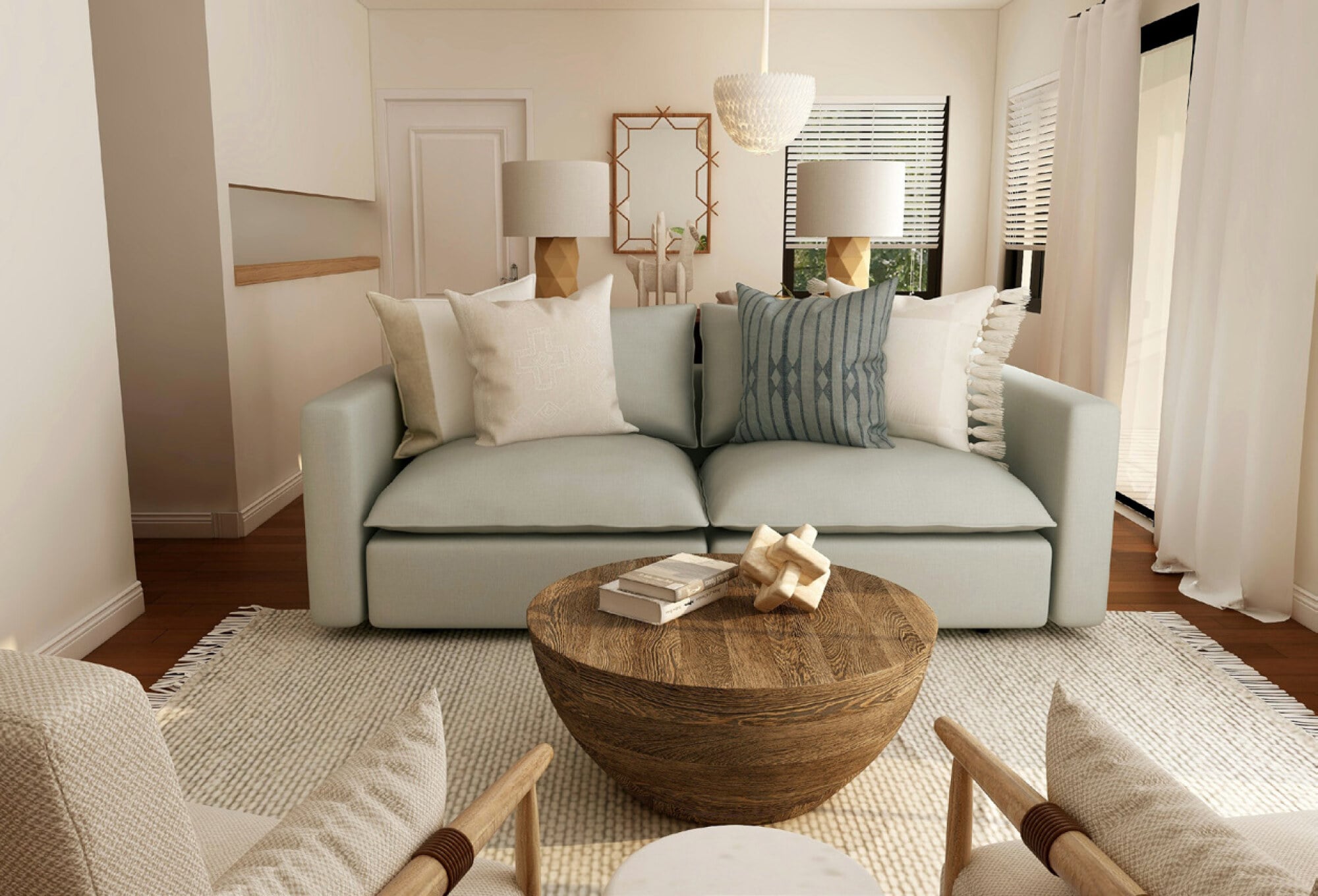 Modern living room with a light sofa, patterned pillows, round wooden coffee table, and neutral decor in soft, natural tones.