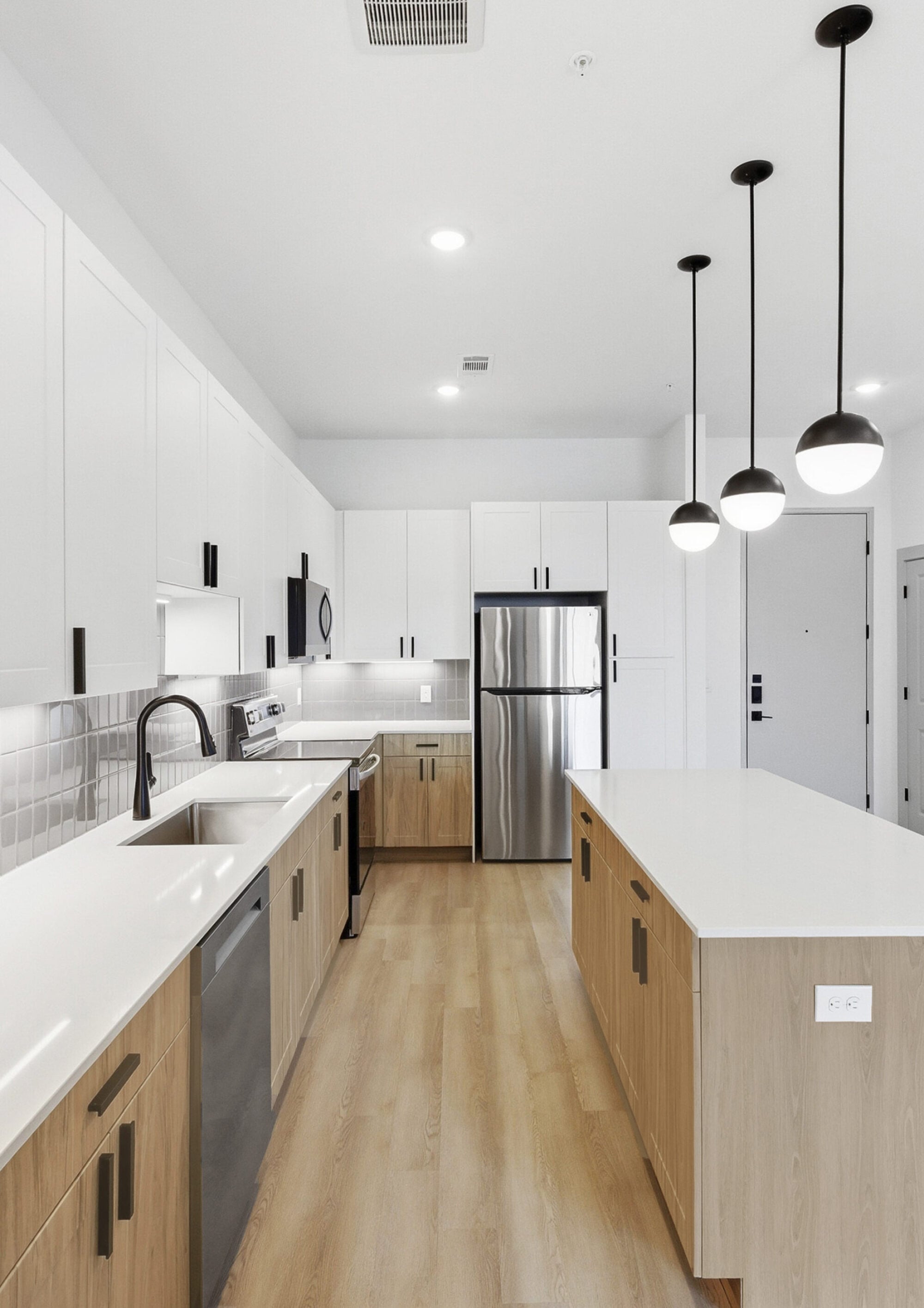 Modern apartment kitchen with quartz countertops and stainless steel appliances in Austin, TX