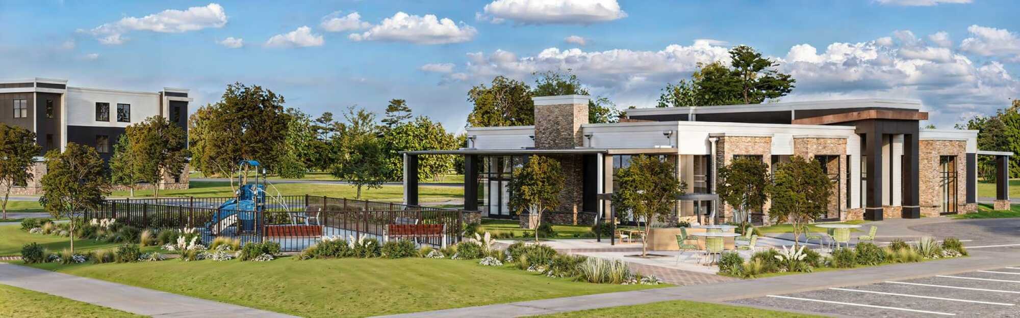 Exterior view of the Linden Village clubhouse featuring modern architecture, stone accents, and lush landscaped surroundings.
