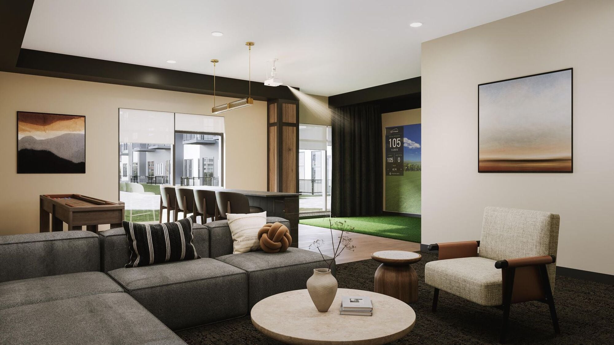 Modern living room with gray sectional, armchair, bar area, wall art, and large windows overlooking a courtyard.