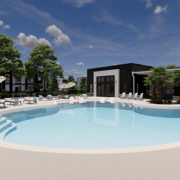 A large swimming pool with lounge chairs and umbrellas in front of a modern building.