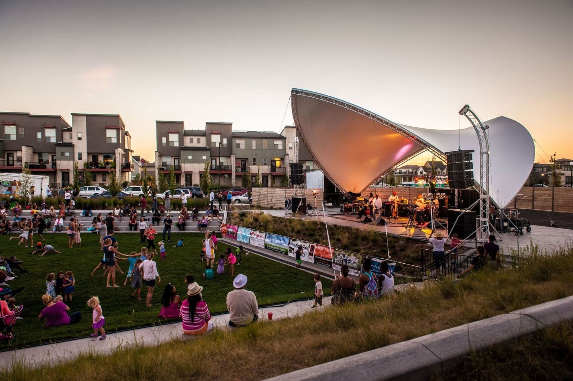People gathering in a park to listen to outdoor music
