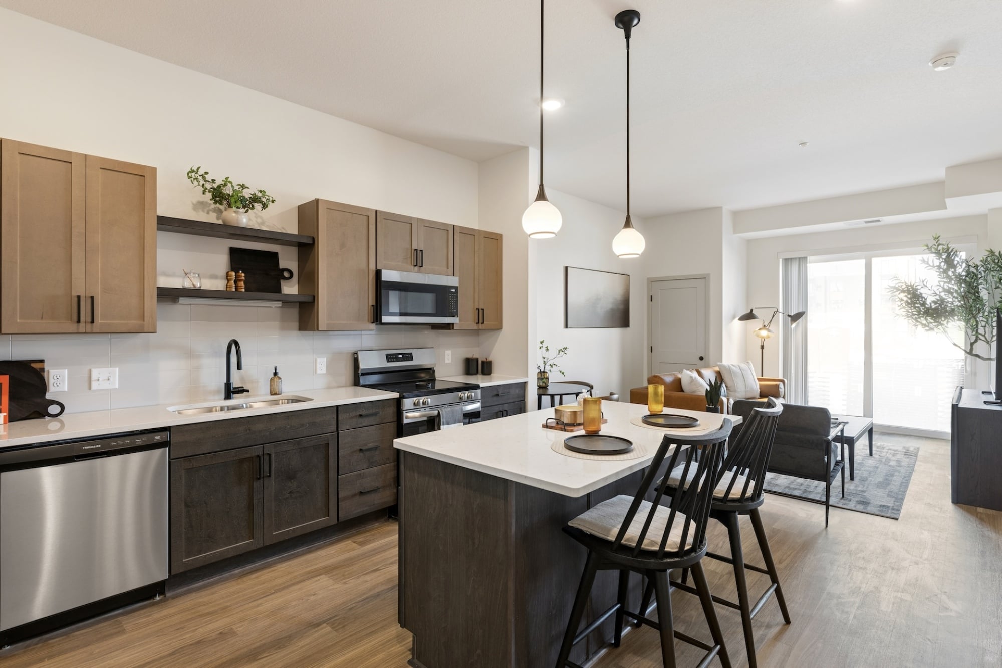 Modern Apartment Kitchen featuring stainless steel applainces, and two-toned cabinetry  at Belterra Apartments in Plymouth MN