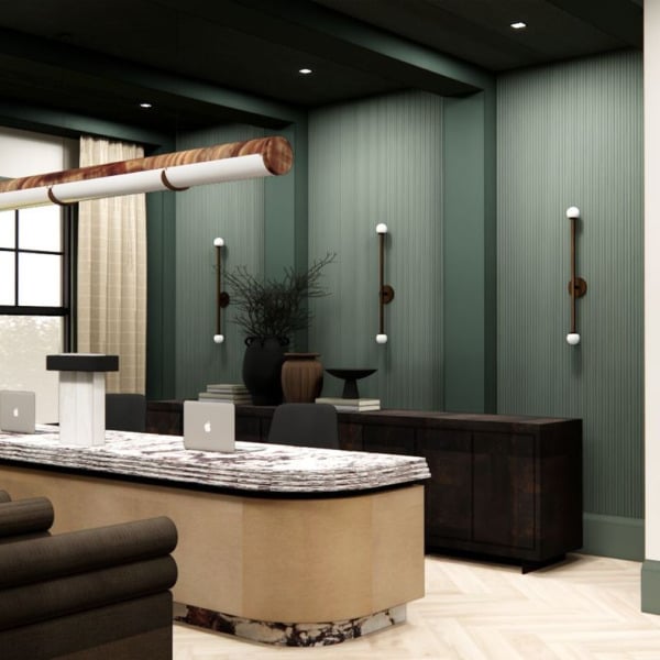 A modern kitchen with a marble backsplash and dark green walls.