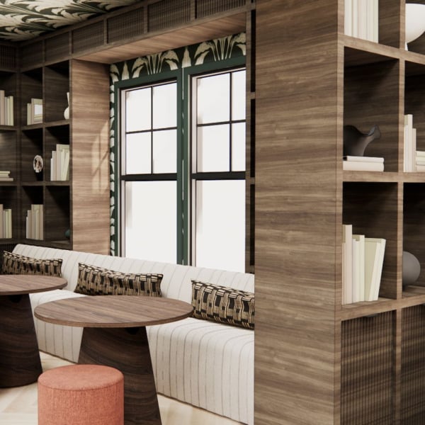 A living room with a sofa, a table, and a bookshelf.