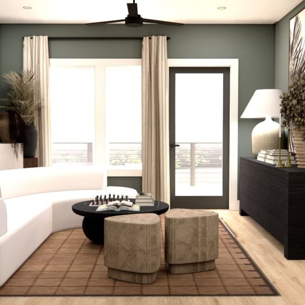 A living room with a white sofa and a large window.