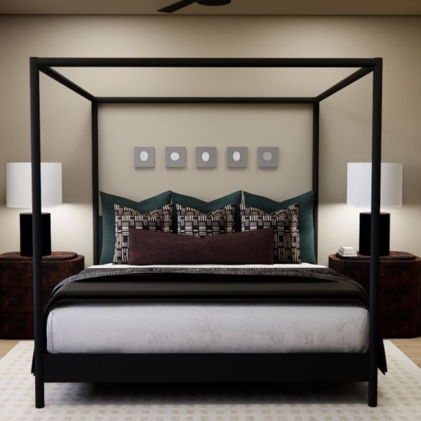 A bedroom with a four poster bed and a painting on the wall.