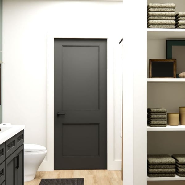 A bathroom with a black door and a white counter.