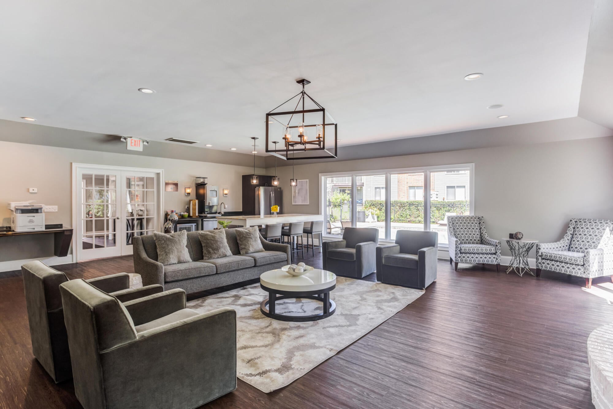 Clubhouse great room with kitchen and bar seating at Ashford at Geneva apartments in Geneva, IL